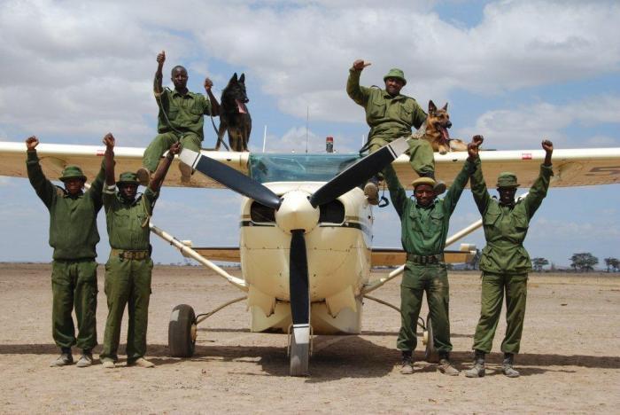 111214 1 2 Jazz and Max Two of Big Lifes Tracker Dogs On the Wing of Richard Bonhams Plane with their Handlers and Other Big Life Rangers