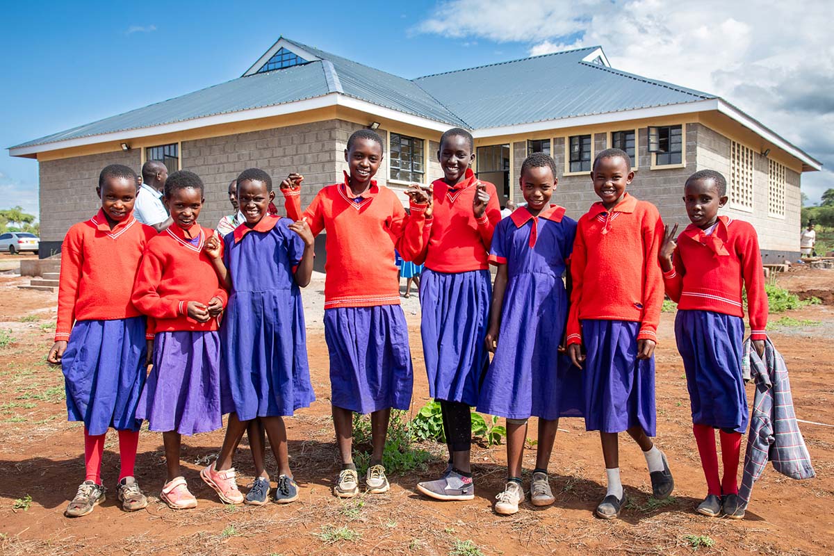 240509 Girls from Ol Donyo Oibor Primary School stand in front of their new dormitory funded by Big Girls Foundation Joshua Clay